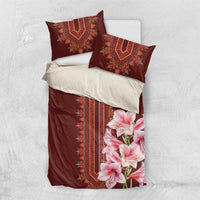 Burgundy duvet cover with red dashiki trim, pink lily print, and matching pillowcases
