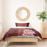Burgundy duvet cover with red dashiki border and pink lily bouquet on bedding set