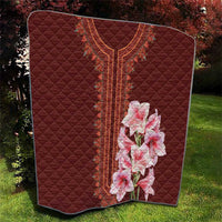 Red quilt blanket with diamond quilting, detailed center stripe and pink lily bouquet