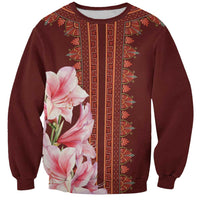 Red dashiki sweatshirt with vertical trim and pink lily print, front