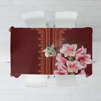 Red tablecloth with pink lily print and central patterned border