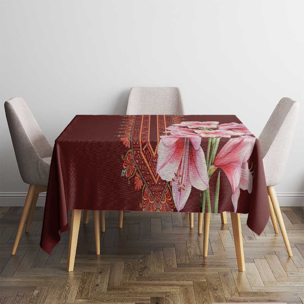 Red tablecloth with pink lily bouquet and woven-style center stripe