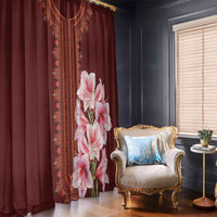 Red dashiki-style window curtain with vertical trim and pink lily bouquet on panel