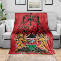 Red Kenya coat of arms blanket with lion graphic and Harambebe emblem, on sofa