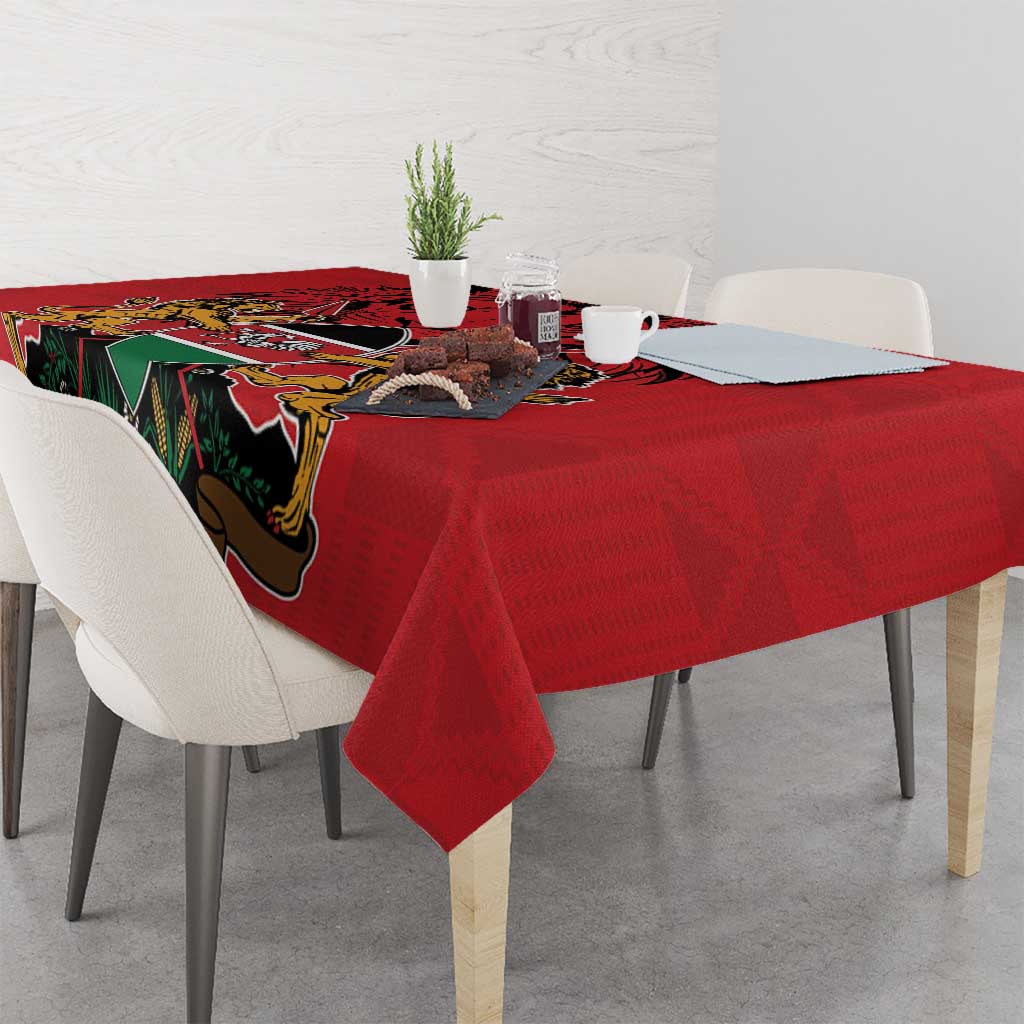 Red tablecloth with coat of arms and Kente-style pattern border