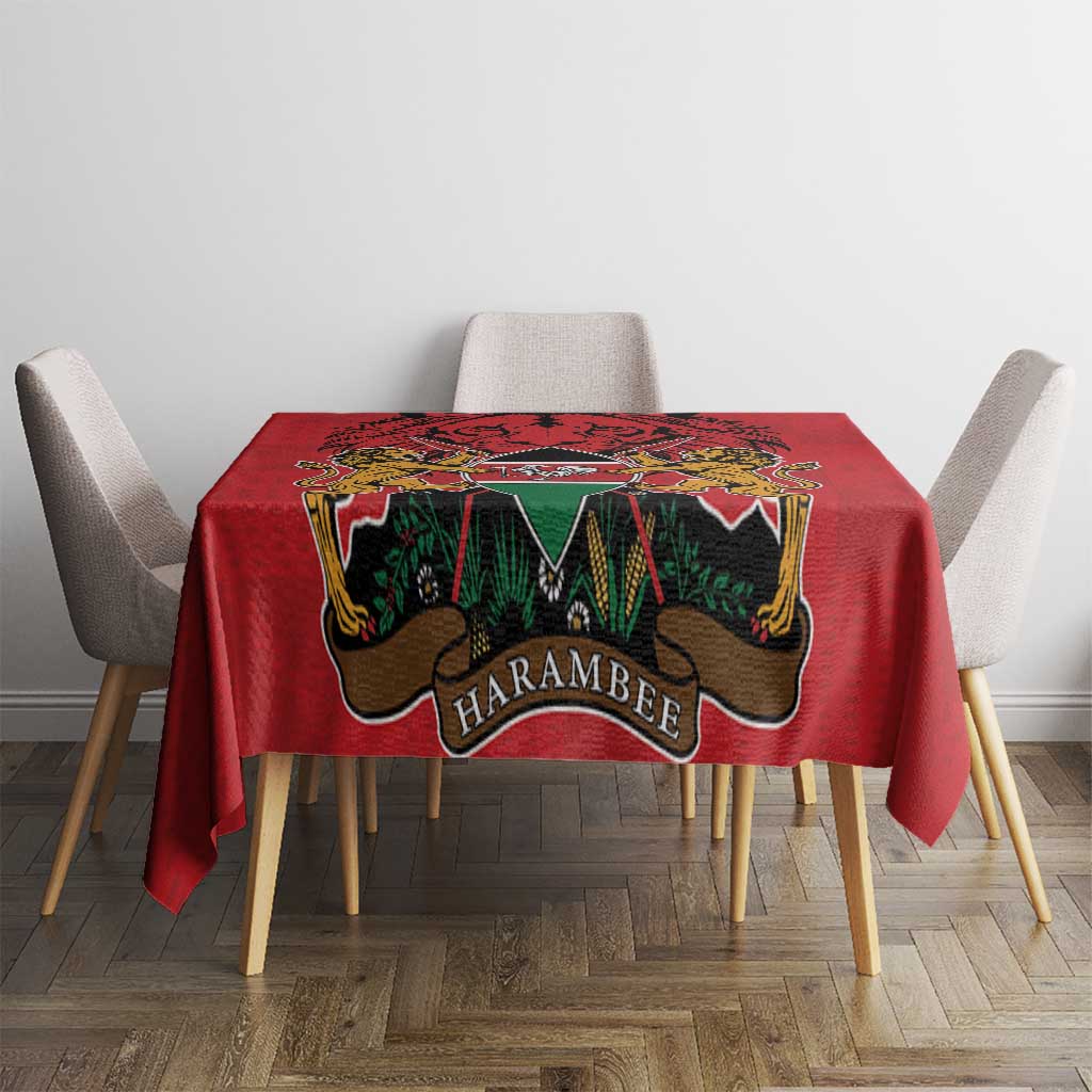 Red tablecloth with centered coat of arms emblem and multicolor Kente-style motifs
