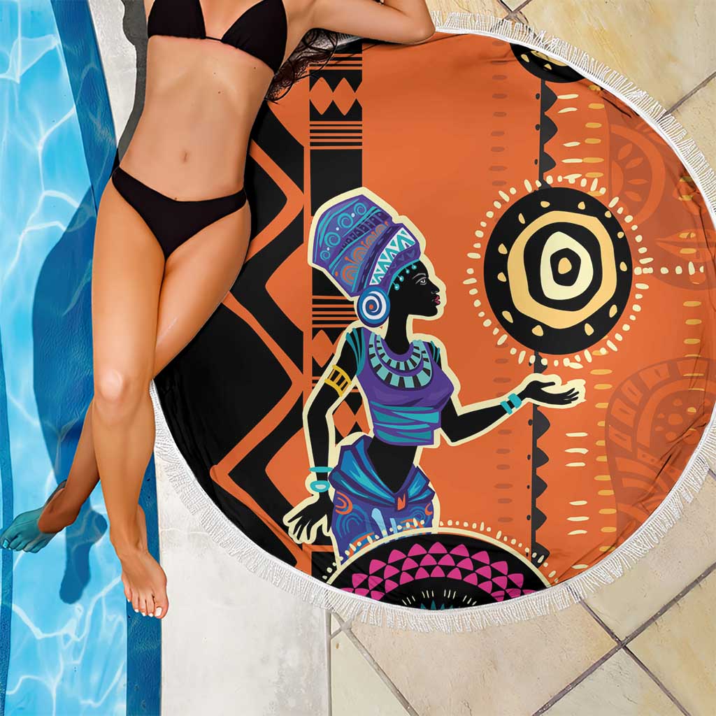 Round orange beach blanket with African woman artwork and decorative geometric motifs, fringe