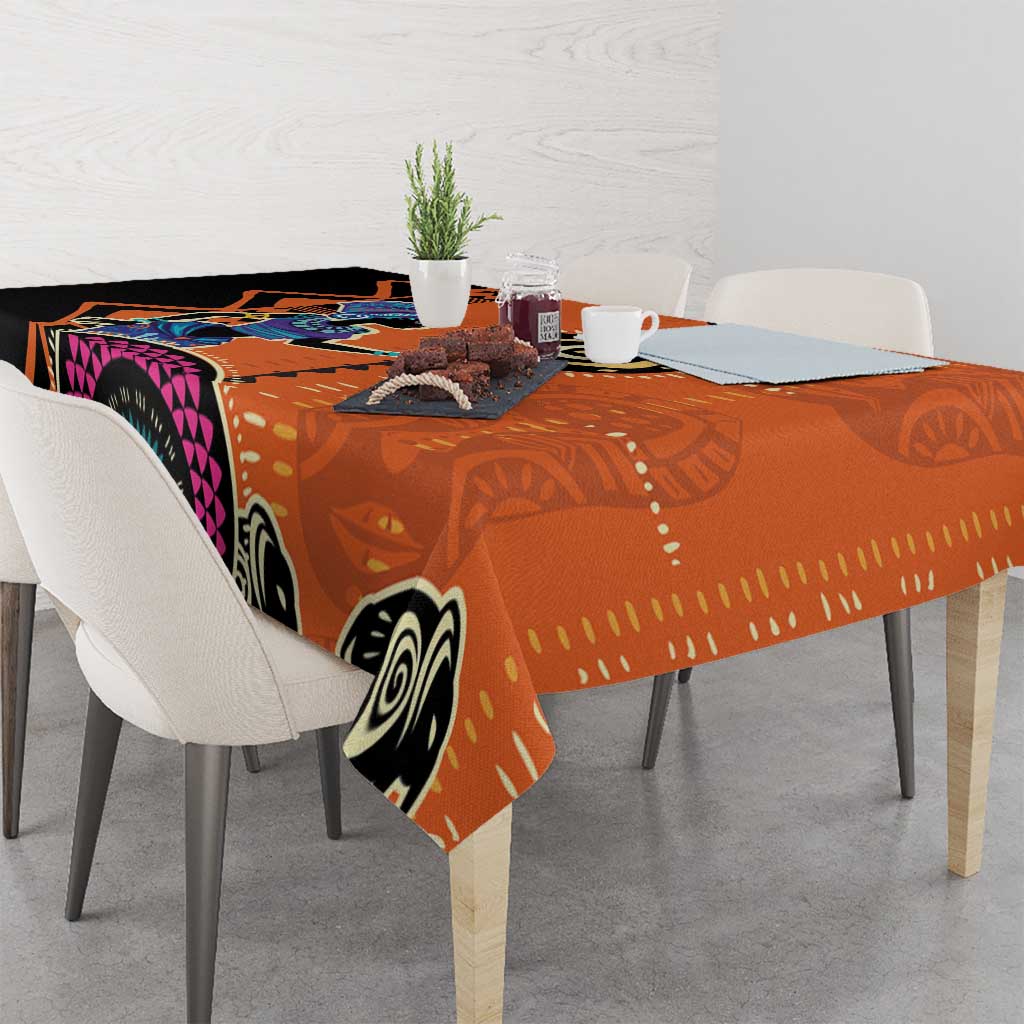 Orange geometric tablecloth with black, white, and purple circles; corner hanging down