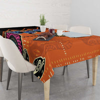 Orange geometric tablecloth with black, white, and purple circles; corner hanging down