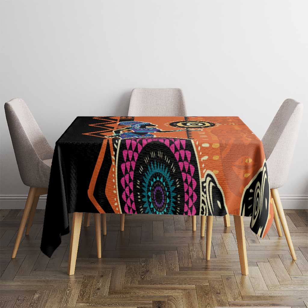 Orange geometric patterned tablecloth with central teal-and-purple circular medallion