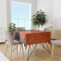 Orange geometric patterned tablecloth with bold circular motifs and purple accents