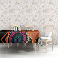 Orange tablecloth with black zigzags, purple sections, and teal circular design