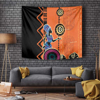African woman ethnic dress tapestry, blue figure holding circular charm on orange panel