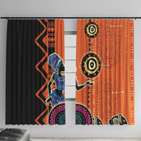 Window curtain pair with black and orange geometric prints and bold circular symbols