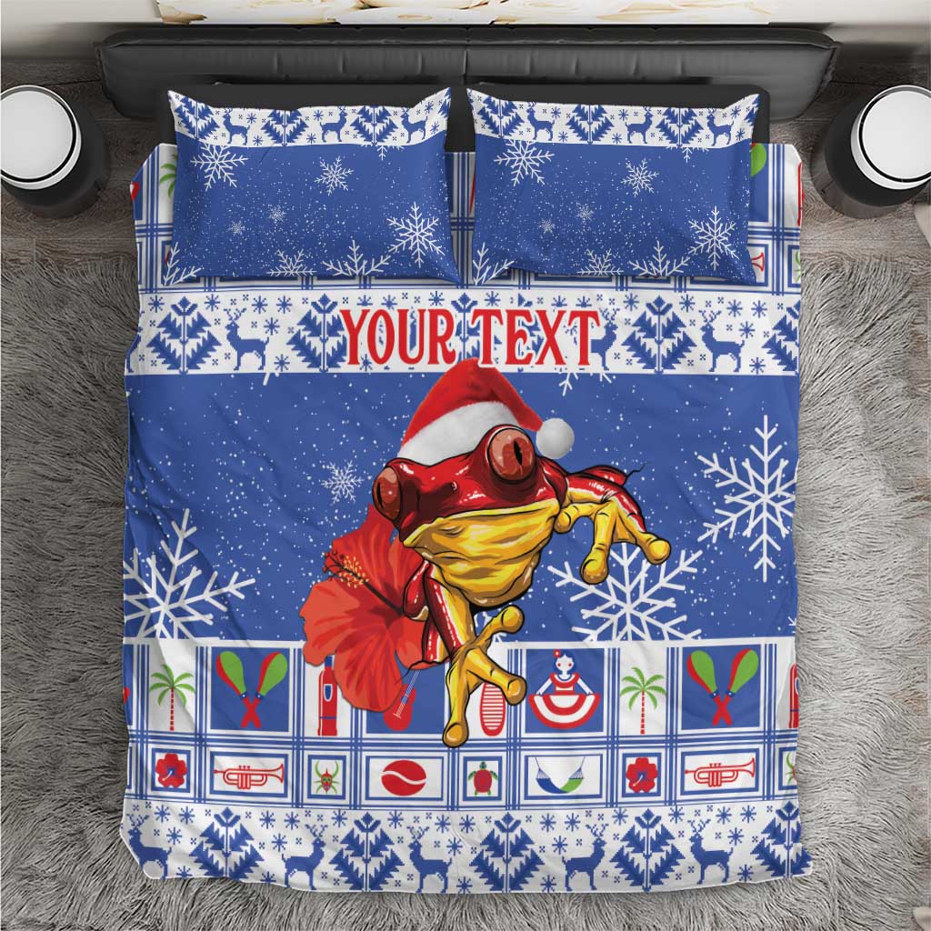 Blue Christmas bedding set with snowflake pattern and red Santa-style coqui character