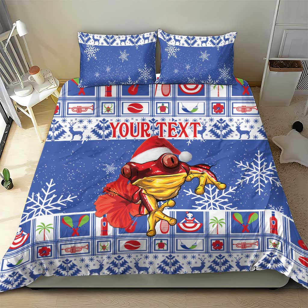 Blue Christmas bedding set featuring snowflakes and a red-and-yellow coqui in Santa hat