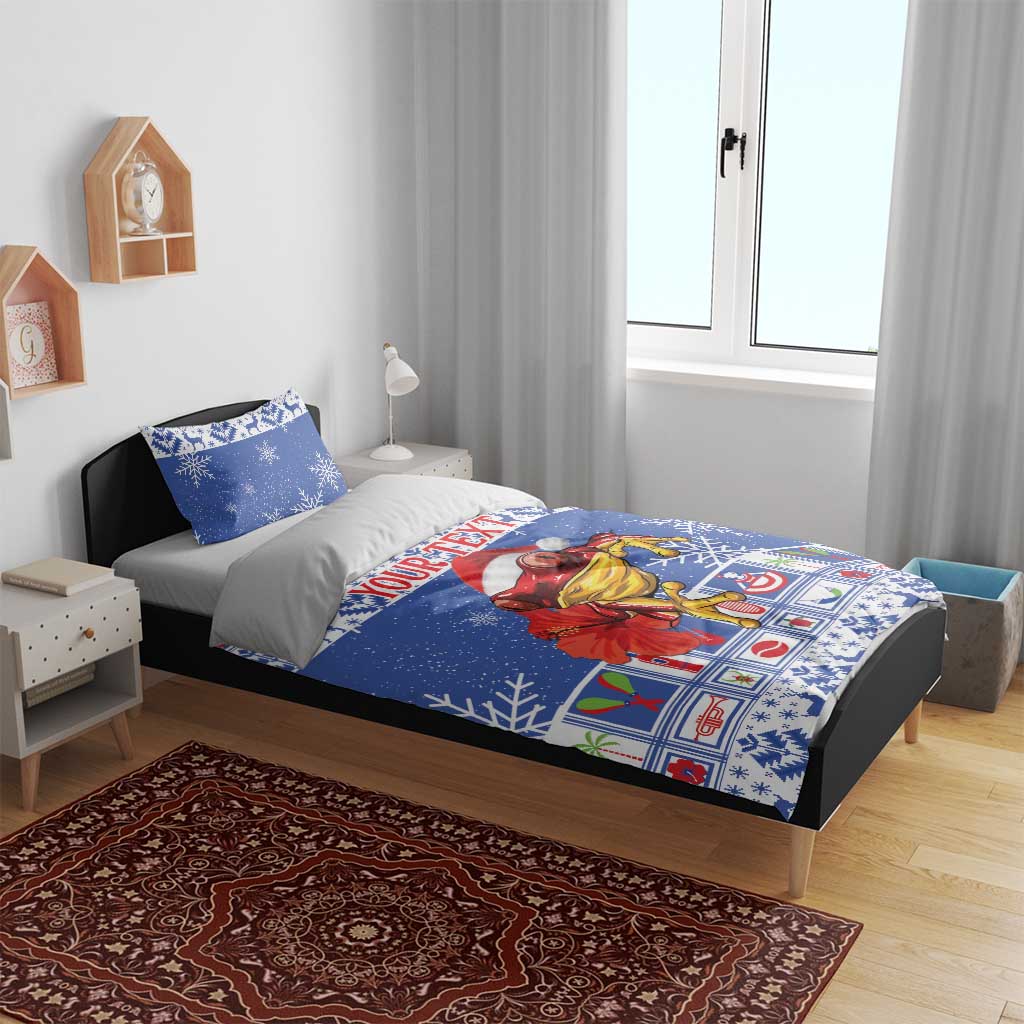 Blue Christmas bedding set on bed with snowflake print and coqui character panel