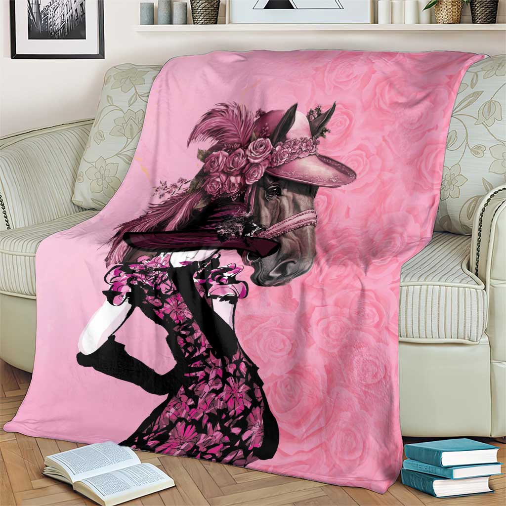 Pink horse-and-rider blanket with rose bouquet print, draped on a chair