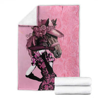 Pink blanket with horse-and-rider illustration and roses, folded for display