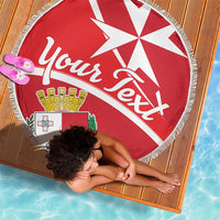 Red round beach blanket with Malta coat of arms and 'You're next' design, fringed border