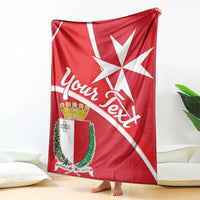 Red Malta flag-style blanket with white Maltese cross, crest emblem, and script text