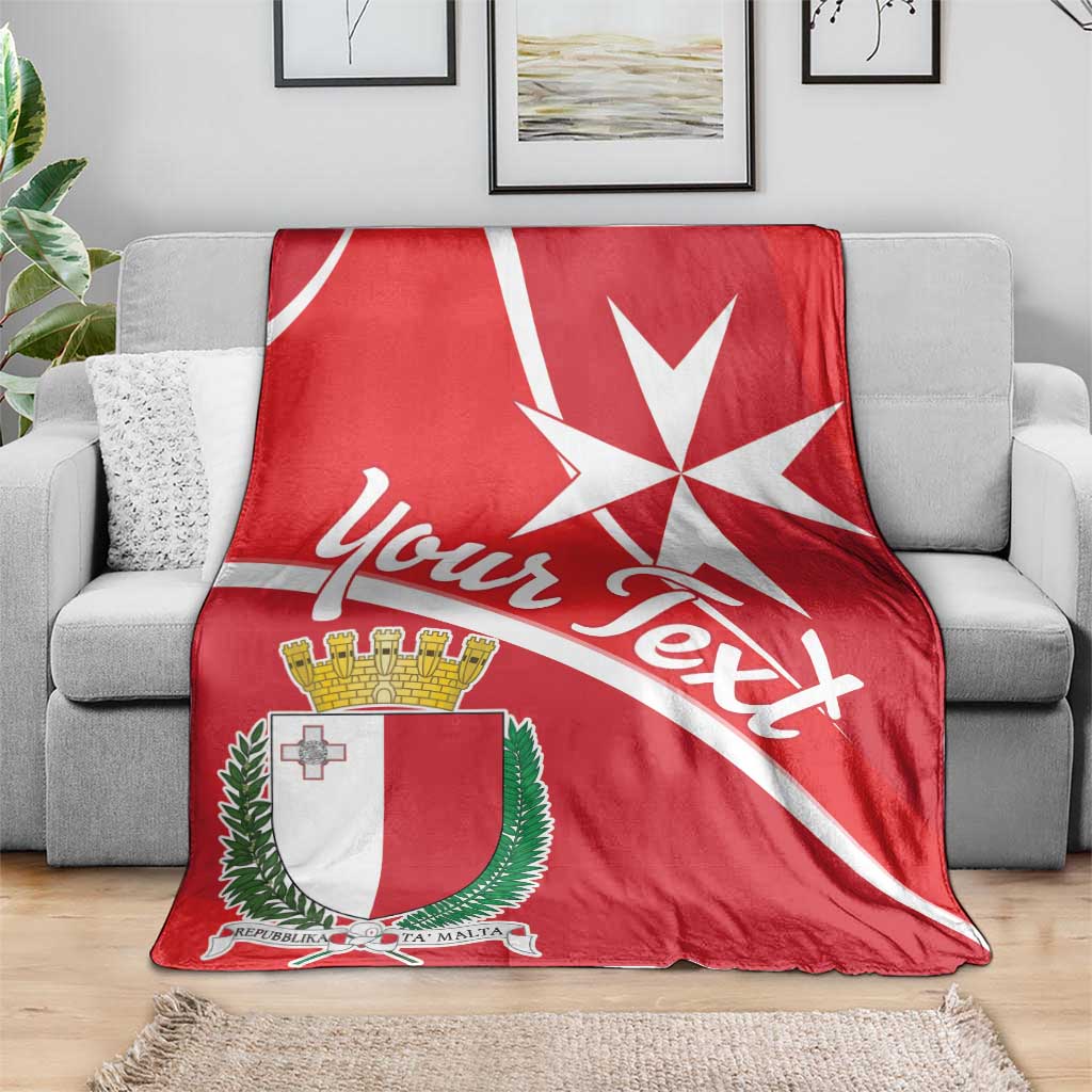 Red personalized Malta coat of arms blanket draped over gray sofa with white cross