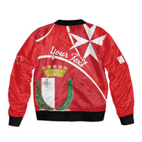 Red bomber jacket with Malta crest graphic on back, black ribbed collar and cuffs