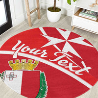 Red round carpet close-up with “Malta” script and white cross-star emblem