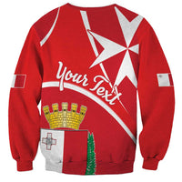 Red crewneck sweatshirt with back print of Maltese cross, cursive text, and shield coat-of-arms