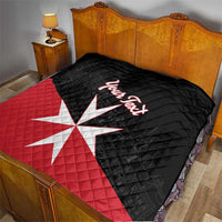Personalized quilt blanket on bed: black and red with Malta cross and “Your Text”