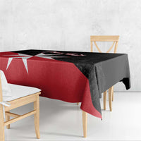 Black and red Malta cross tablecloth draped over a rectangular dining table