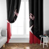 Black window curtain panel with white Malta cross and red personalized script, tied at side