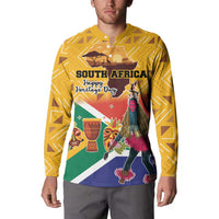 Yellow button sweatshirt with Heritage Day graphic featuring dancer, masks, and flags front.