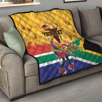 Yellow quilt draped on sofa with South Africa flag colors and custom text