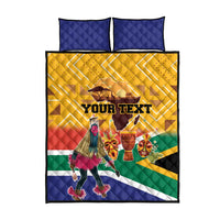 Yellow quilt with multicolor dancer and mask print, plus two blue quilted pillow covers