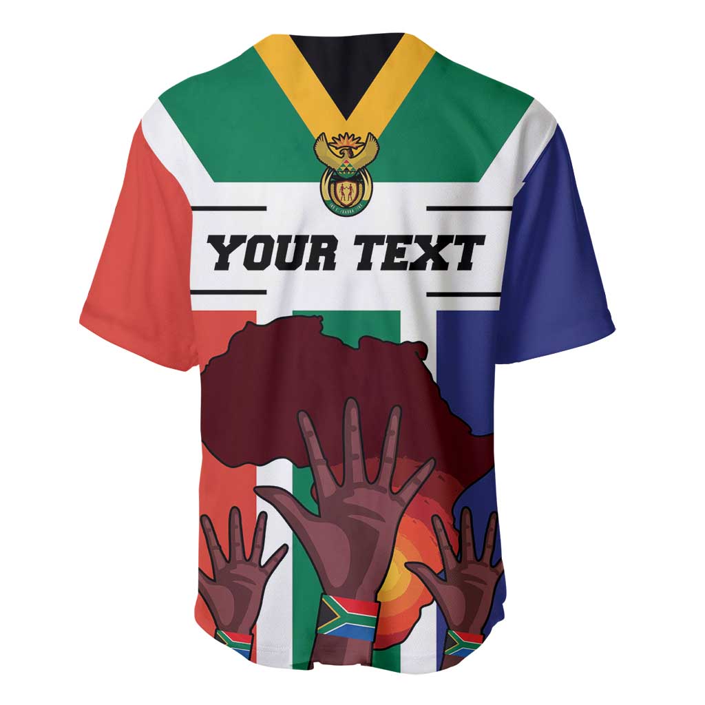 Flag-style baseball jersey with crest logo, yellow-and-black collar, and hands graphic