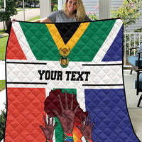 Personalized South Africa heritage quilt held up, flag colors with 'YOUR TEXT' in the center