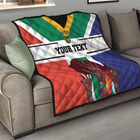 Personalized quilt on sofa with South Africa flag colors, 'YOUR TEXT' center, quilted hands