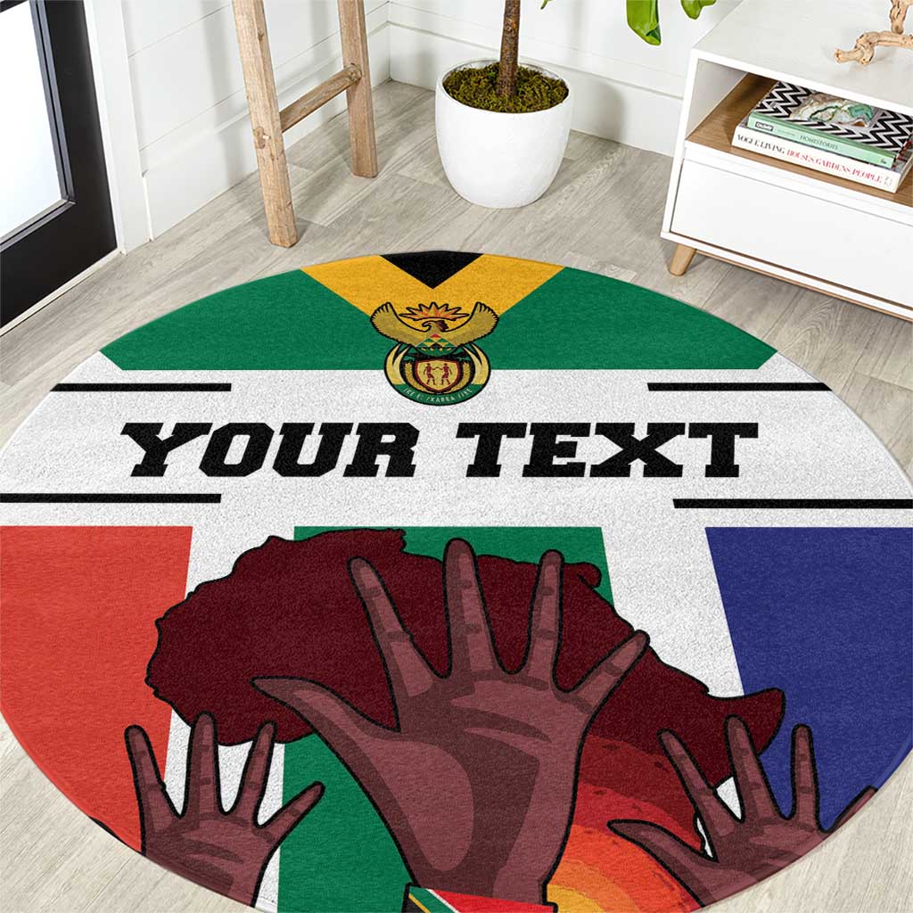 Round carpet close-up with 'YOUR TEXT' and multicolor South Africa flag hand artwork