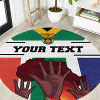Round carpet close-up with 'YOUR TEXT' and multicolor South Africa flag hand artwork