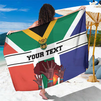 Flag-style sarong held up with custom text and South Africa themed hand graphic