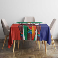 Flag-style tablecloth on a dining table with colorful vertical panel pattern and blue side drape