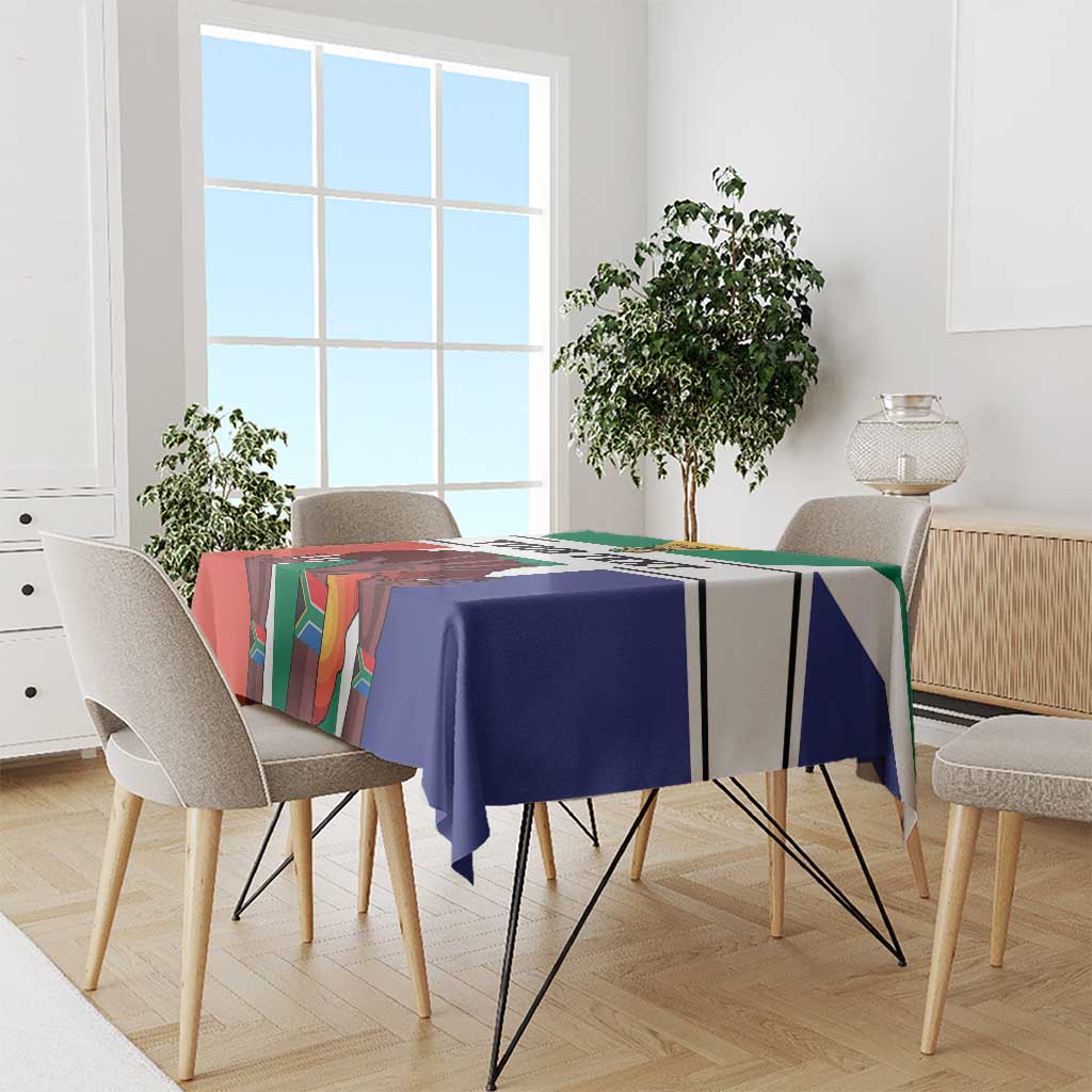 Flag-style tablecloth on a dining table, blue center with multicolor vertical stripes and borders