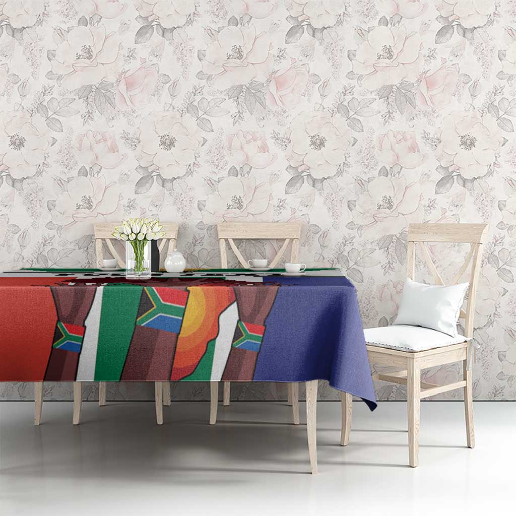 Flag-style tablecloth on a long dining table, blue cloth with red green panels and white trim