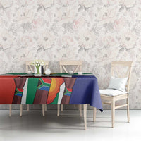 Flag-style tablecloth on a long dining table, blue cloth with red green panels and white trim