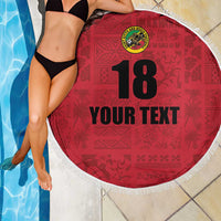 Red round beach blanket with white fringe, island crest, number 18 and custom text, near pool