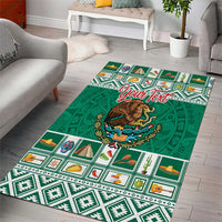 Green area rug with bold Mexican Aztec patterning and a large central coat of arms