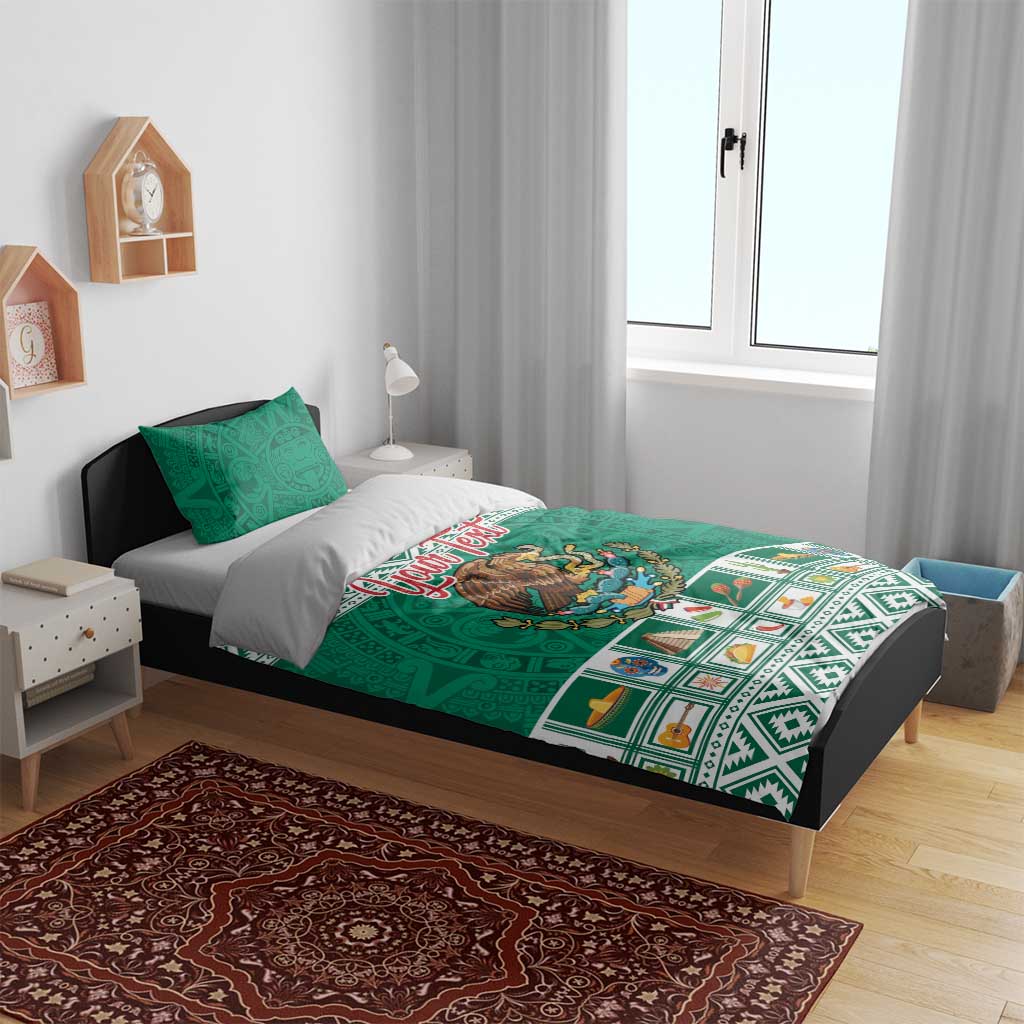Green Aztec-style bedding set with eagle emblem and decorative border, plus two pillowcases