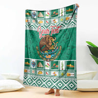 Green blanket with eagle coat of arms, Aztec patterns, and red "Your Text"