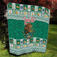 Green quilted blanket featuring Aztec-style patterned border and central Mexico crest.